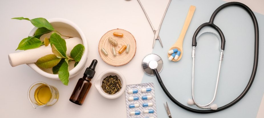 natural medicine products on a table next to stethoscope 