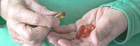 elderly hands with supplements