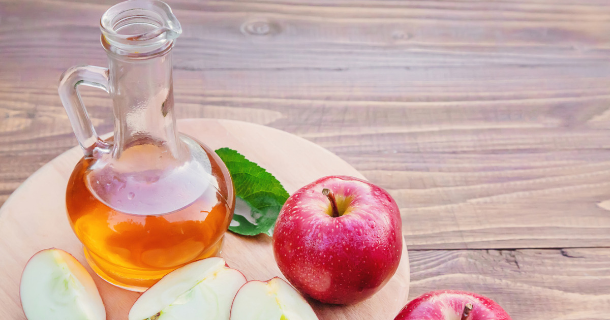 apples and apple cider vinegar on a table