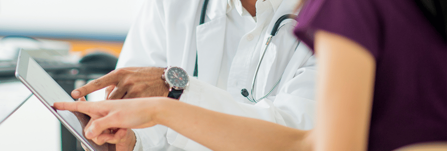doctor showing tablet to patient-2000x677