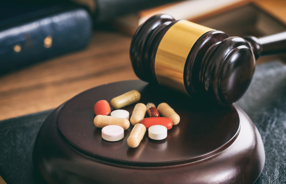 Law gavel and colorful pills