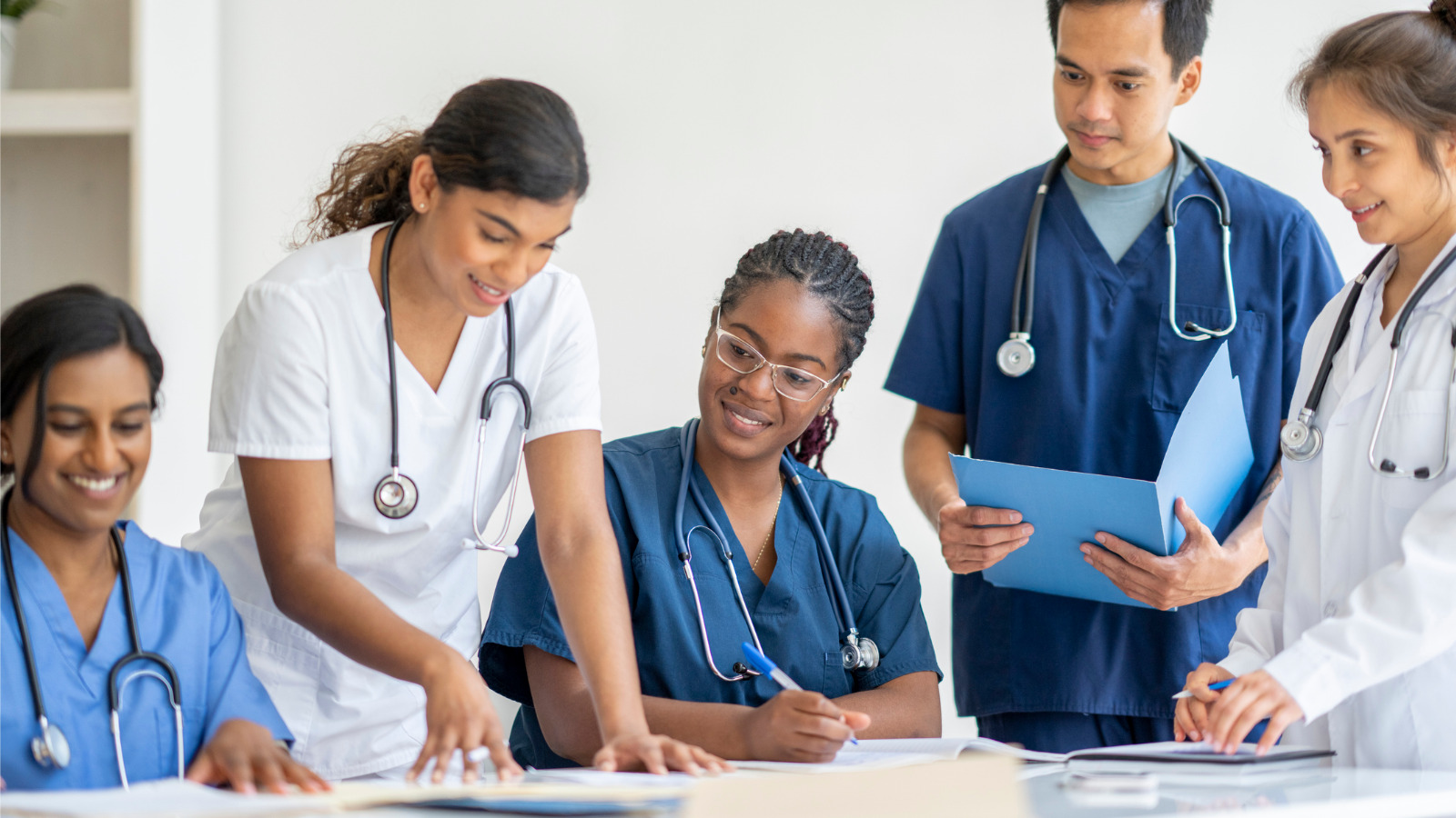 five healthcare workers gathered at a table